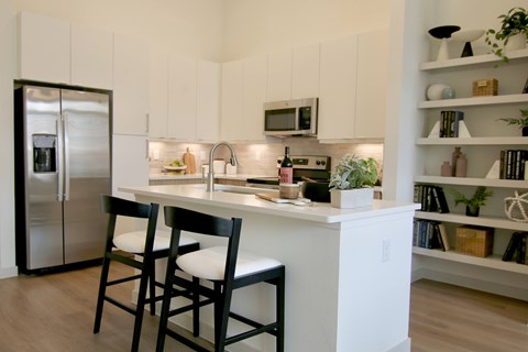 a kitchen with a counter and two stools